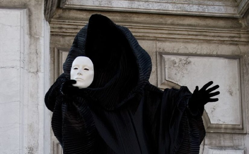 black-figure-staying-on-the-steps-holding-in-the-hand-white-face-mask-venice-masquerade.jpg